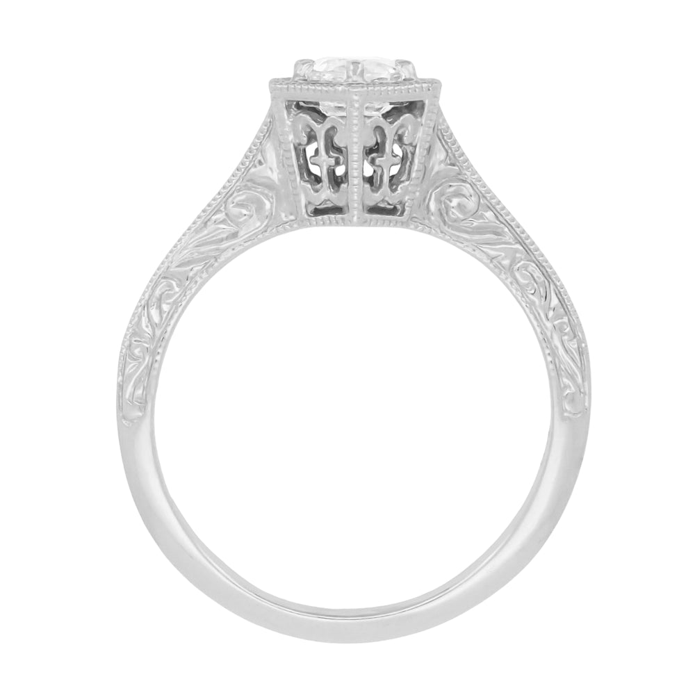 An ornate white gold white sapphire engagement ring with a filigree setting, patterned shank and a round-cut white sapphire center stone, shown on the side against a plain white background. R180W33WS