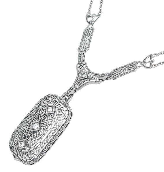 An ornate sterling silver filigree diamond  pendant necklace with a rectangular pendant and chain, shown on a plain white background. N188