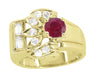 A Mid Century Retro Modern vintage style 14 karat yellow gold ring featuring a large red ruby center gemstone, flanked by smaller white diamond accents, set in a classic 4 prong setting. R1148Y