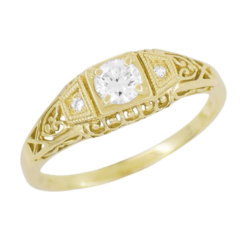An Art Deco style 14K yellow gold white sapphire engagement ring with a low dome and filigree details on the sides. R228YWS