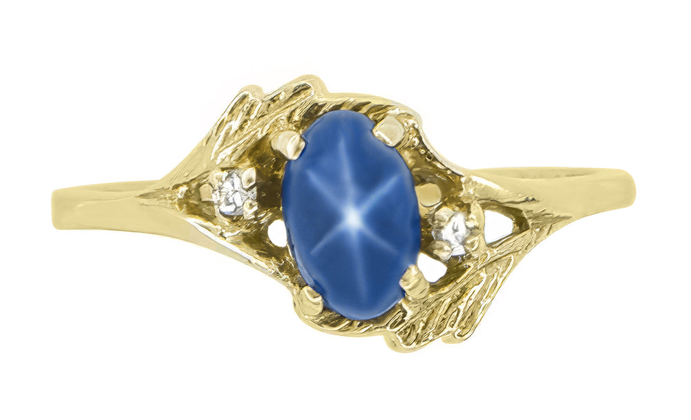1970s Oval Blue Star Sapphire Cabochon Bypass Twist Ring in Yellow Gold with Side Diamonds