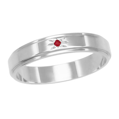 A vintage 1950s era 14K white gold men's wedding band with a grooved edge and a round brilliant red ruby at the center, set within a hand engraved starburst design. R653WR