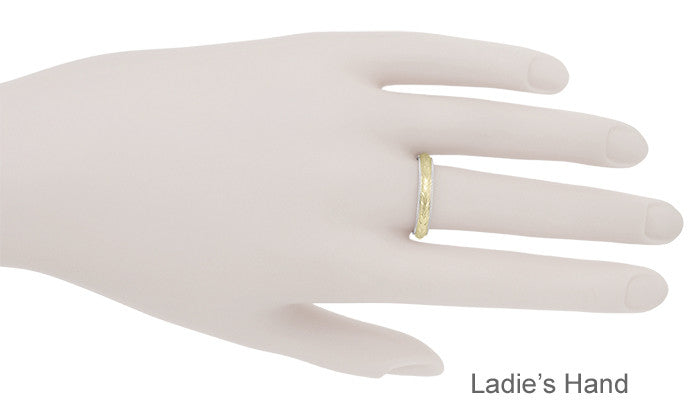 A gold band ring displayed on a mannequin hand labeled 'Ladie's Hand' against a plain white background.