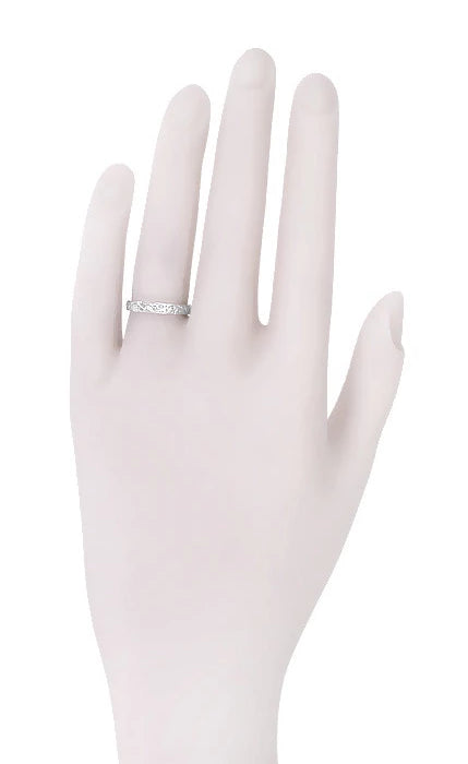 R626P platinum wedding ring on woman's hand